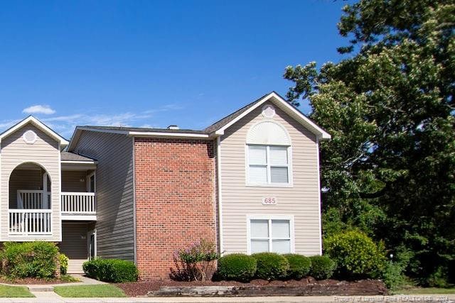 view of side of property with a balcony