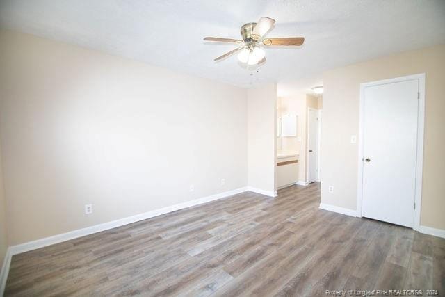 unfurnished room with hardwood / wood-style floors and ceiling fan