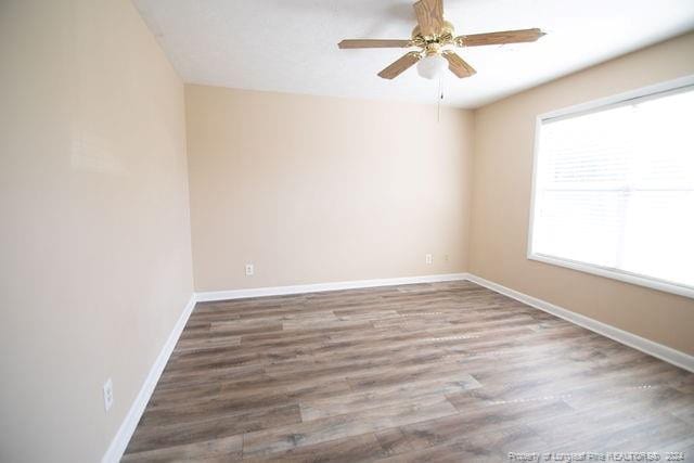 spare room with ceiling fan and hardwood / wood-style flooring