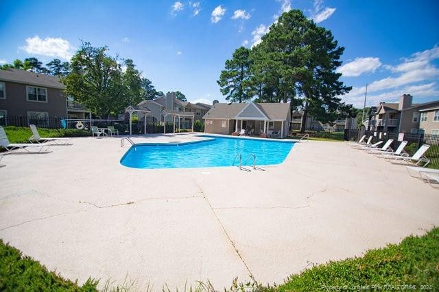 view of swimming pool featuring a patio area