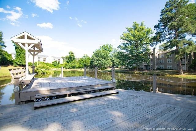 view of dock with a deck with water view