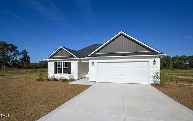 view of front of property featuring a garage and a front yard