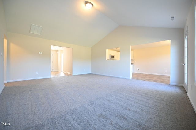 empty room with lofted ceiling and carpet flooring