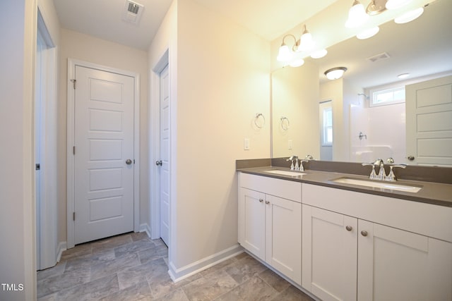 bathroom with vanity and a shower