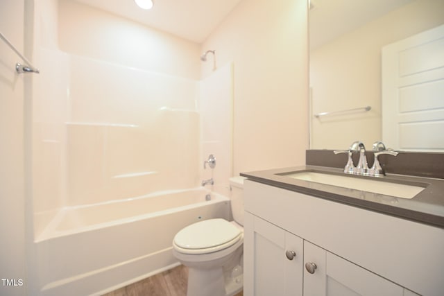 full bathroom featuring vanity, wood-type flooring, shower / washtub combination, and toilet