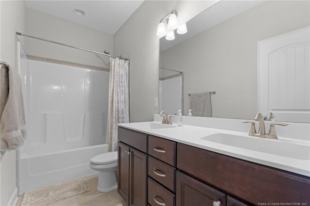 bathroom featuring shower / bath combo, tile patterned flooring, double vanity, and a sink
