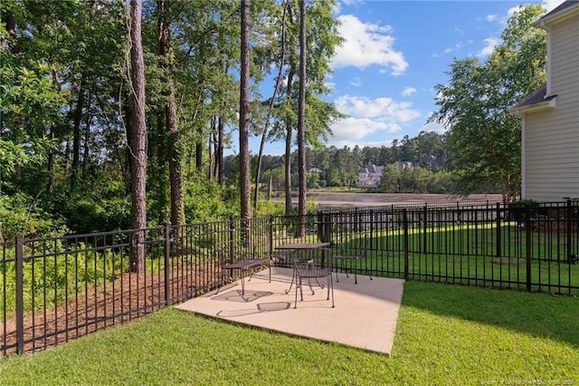 view of yard featuring fence and a patio