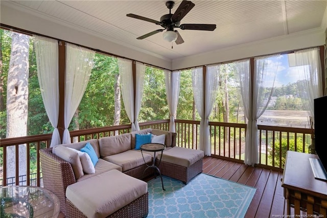 sunroom with a ceiling fan and an outdoor hangout area