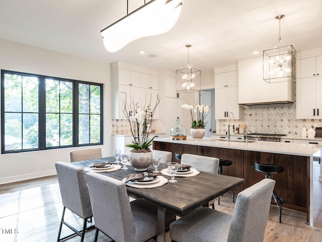 dining space featuring light hardwood / wood-style flooring and sink