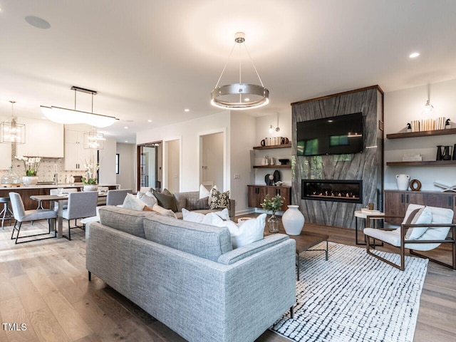 living room with light hardwood / wood-style floors and a premium fireplace