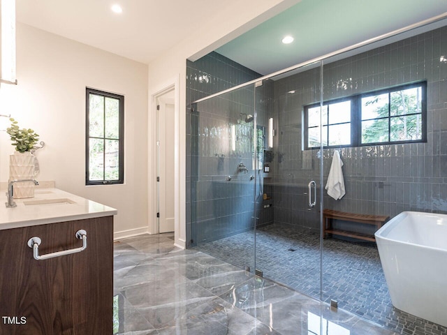 bathroom featuring vanity and independent shower and bath