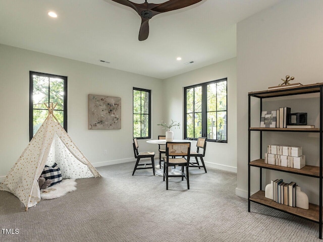 game room with ceiling fan, plenty of natural light, and carpet