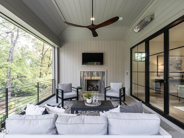 sunroom featuring a fireplace, vaulted ceiling, ceiling fan, and wooden ceiling