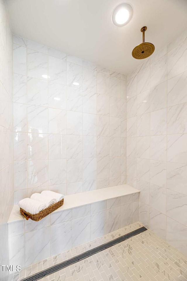 bathroom featuring tile walls and tiled shower