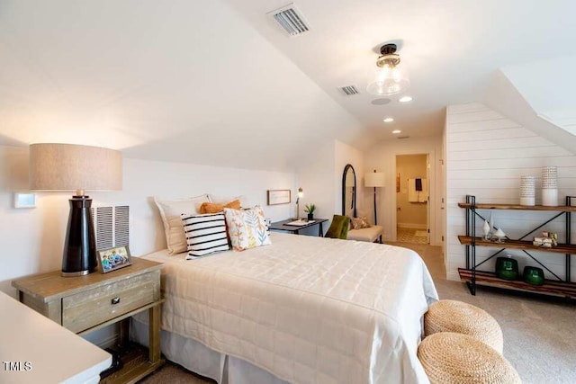 carpeted bedroom featuring ensuite bathroom and vaulted ceiling