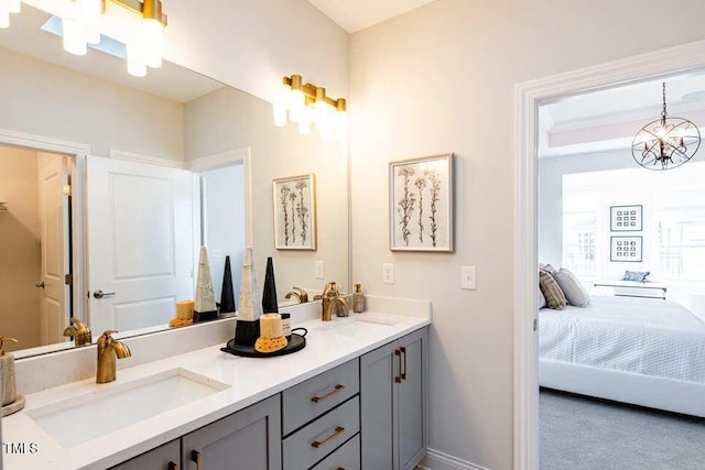 bathroom with vanity and a notable chandelier