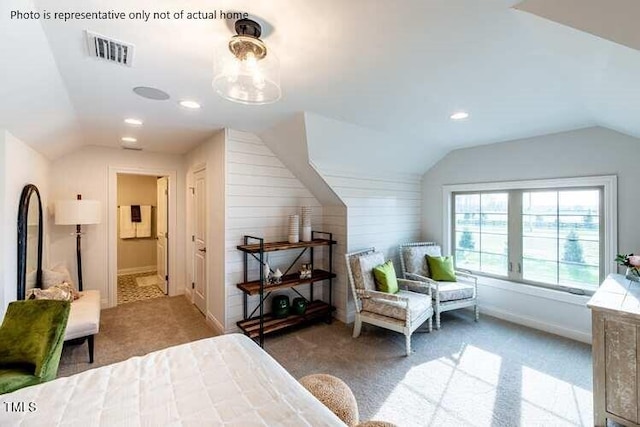 bedroom featuring connected bathroom, vaulted ceiling, and light colored carpet