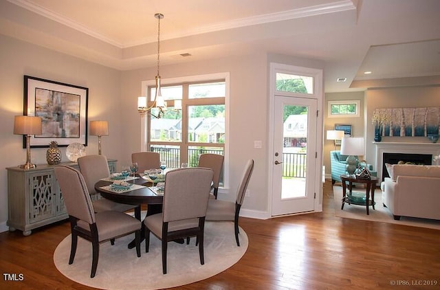 1005 Bridgeforth Ln, Durham, NC 27713 - dining room featuring a raised ceiling, wood finished floors, ornamental molding, a chandelier, and baseboards