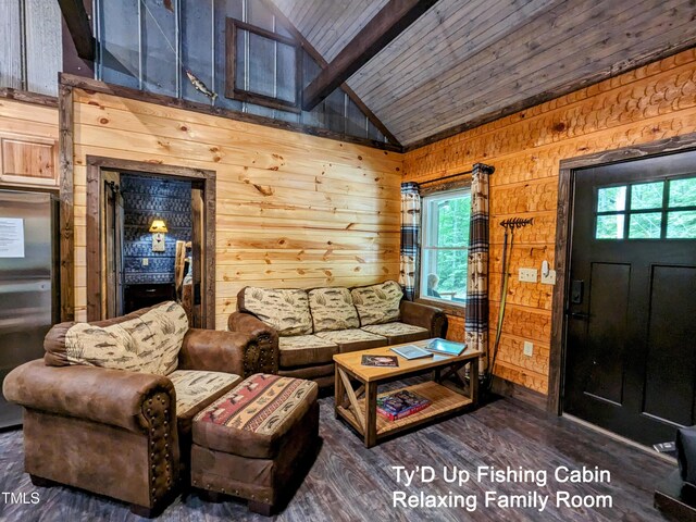 living room featuring vaulted ceiling with beams, plenty of natural light, wooden walls, and dark wood-type flooring