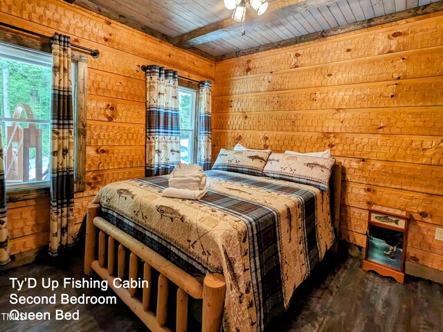 bedroom featuring wooden ceiling, wooden walls, dark wood-type flooring, and multiple windows