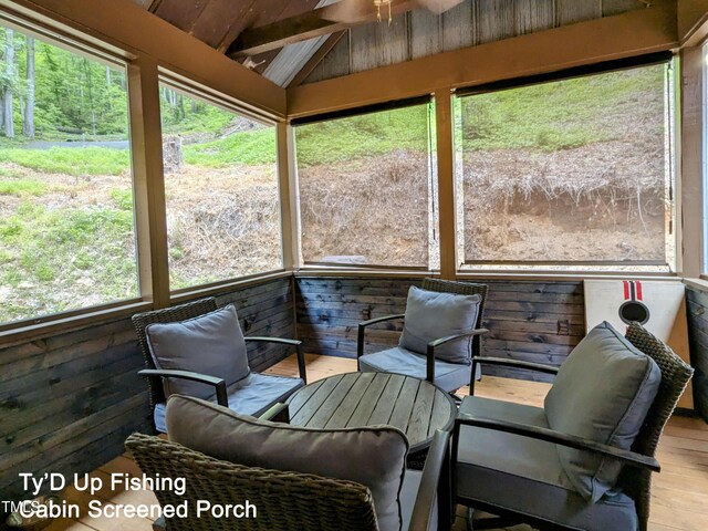 sunroom with vaulted ceiling with beams