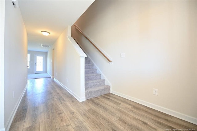 stairway featuring wood-type flooring