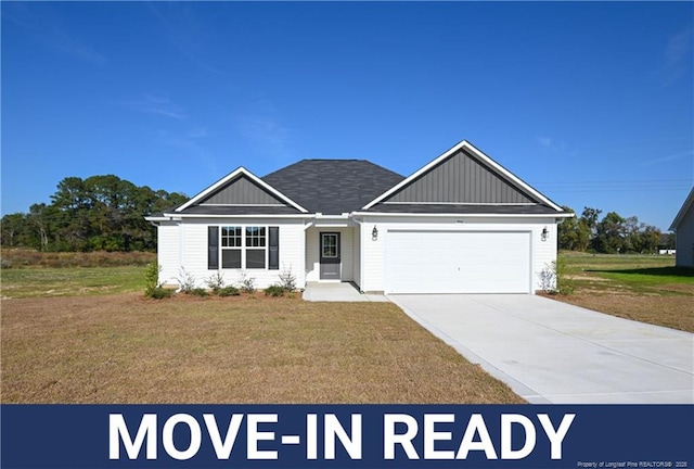 view of front of property with a garage and a front yard