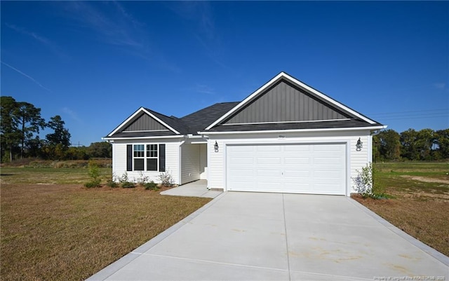 view of front of house with a garage and a front lawn