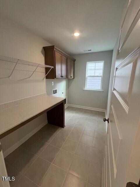 laundry room featuring washer hookup, hookup for an electric dryer, and cabinets