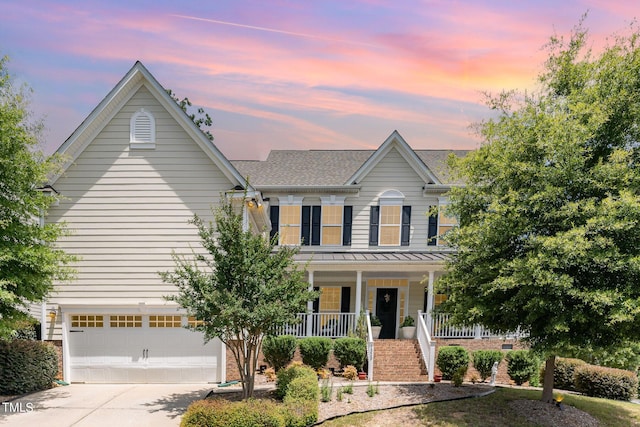 1329 Endgame Ct, Wake Forest, NC 27587 - view of front of house with covered porch, concrete driveway, a garage, a standing seam roof, and roof with shingles