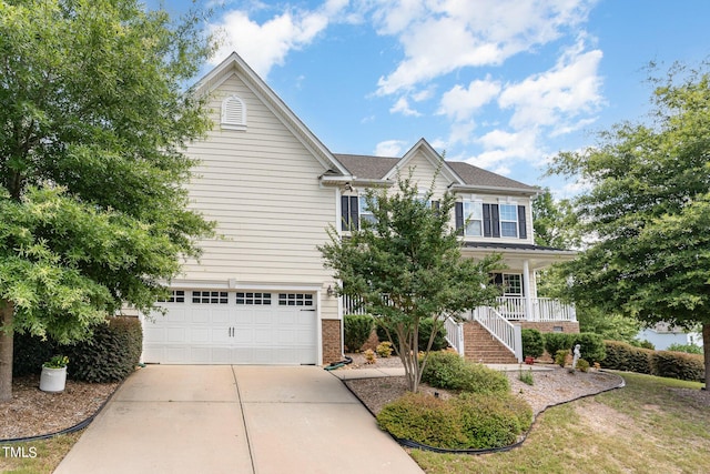 1329 Endgame Ct, Wake Forest, NC 27587 - view of front of house featuring driveway, a garage, stairs, brick siding, and covered porch
