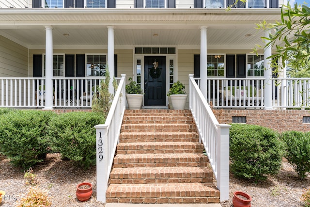 entrance to property featuring covered porch