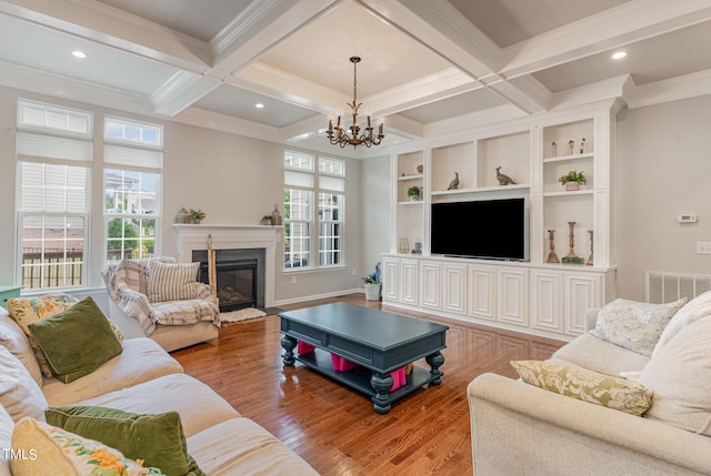 living room featuring wood-type flooring, beamed ceiling, coffered ceiling, and a chandelier