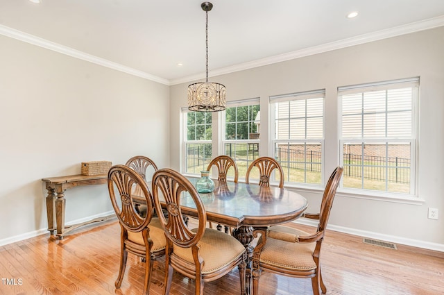 1329 Endgame Ct, Wake Forest, NC 27587 - dining room with a chandelier, baseboards, light wood finished floors, crown molding, and recessed lighting