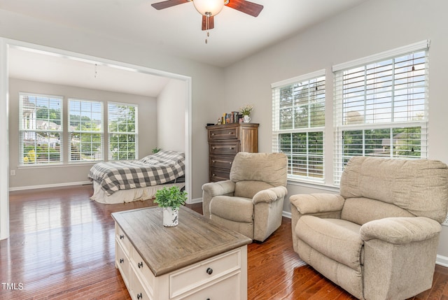 living room with dark wood-type flooring and ceiling fan