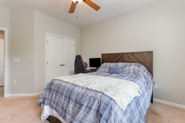 bedroom with ceiling fan, a closet, and light colored carpet