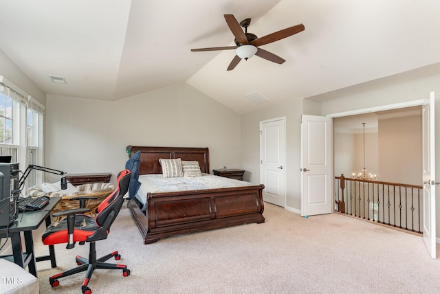 bedroom with carpet, ceiling fan with notable chandelier, and vaulted ceiling