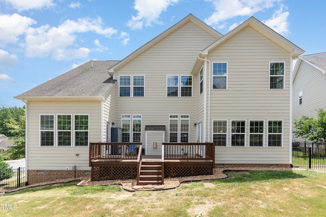 back of house featuring a deck and a lawn