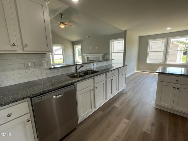 kitchen featuring a sink, backsplash, dishwasher, dark wood-style floors, and white cabinets