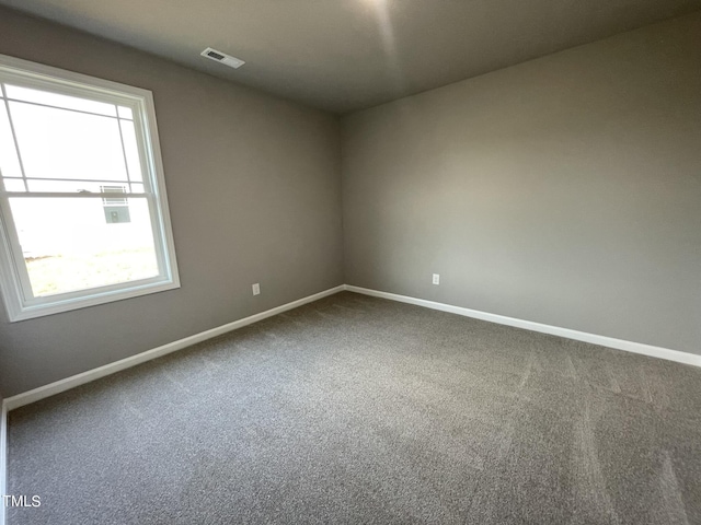 unfurnished room featuring baseboards, visible vents, and carpet floors