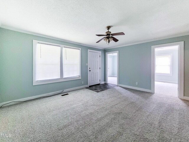 interior space with a textured ceiling, ceiling fan, and ornamental molding