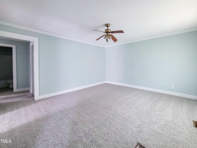 carpeted spare room featuring ceiling fan and crown molding