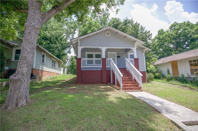 bungalow-style house with a porch and a front yard