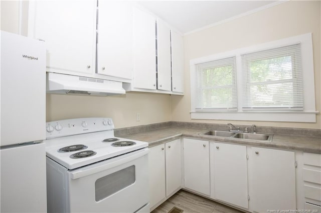 kitchen with a sink, white appliances, under cabinet range hood, crown molding, and white cabinetry