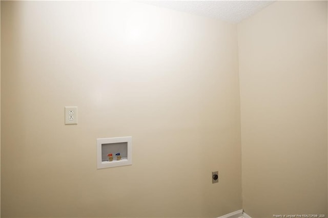 laundry room with hookup for an electric dryer, baseboards, a textured ceiling, laundry area, and hookup for a washing machine