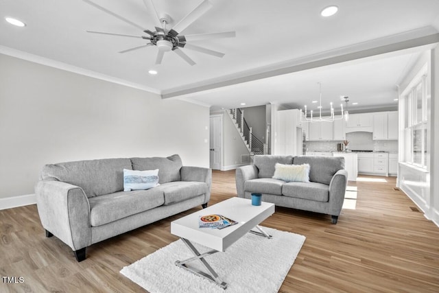 living room featuring crown molding, ceiling fan, and light hardwood / wood-style floors