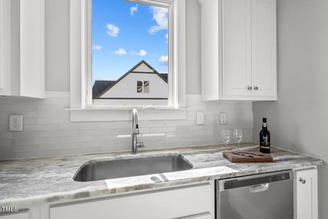 kitchen featuring white cabinetry, sink, light stone counters, and dishwasher