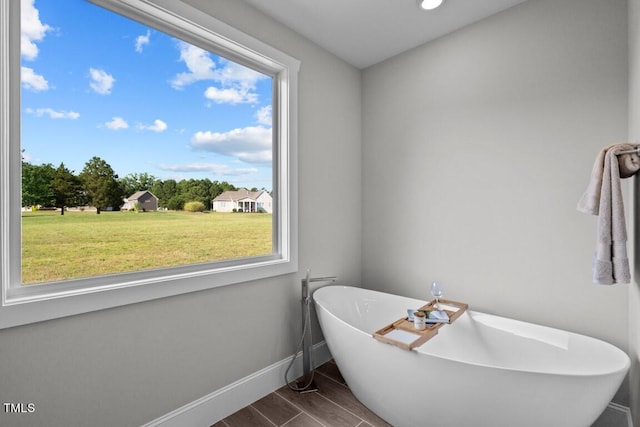 bathroom with plenty of natural light and a bathtub