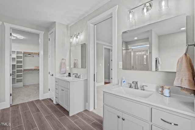 bathroom with a shower with door and vanity