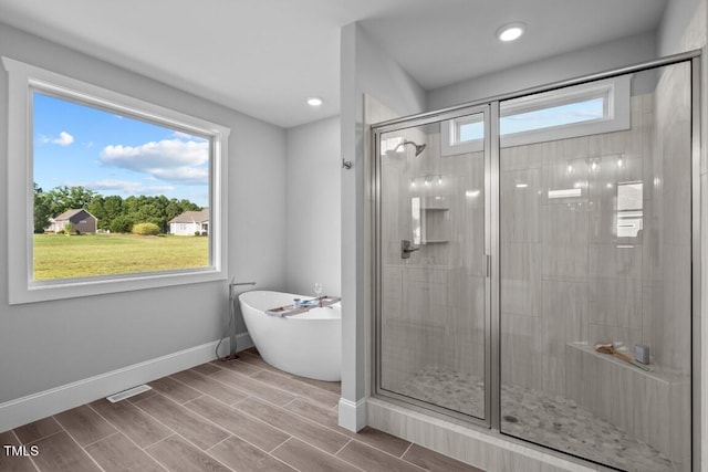 bathroom featuring separate shower and tub